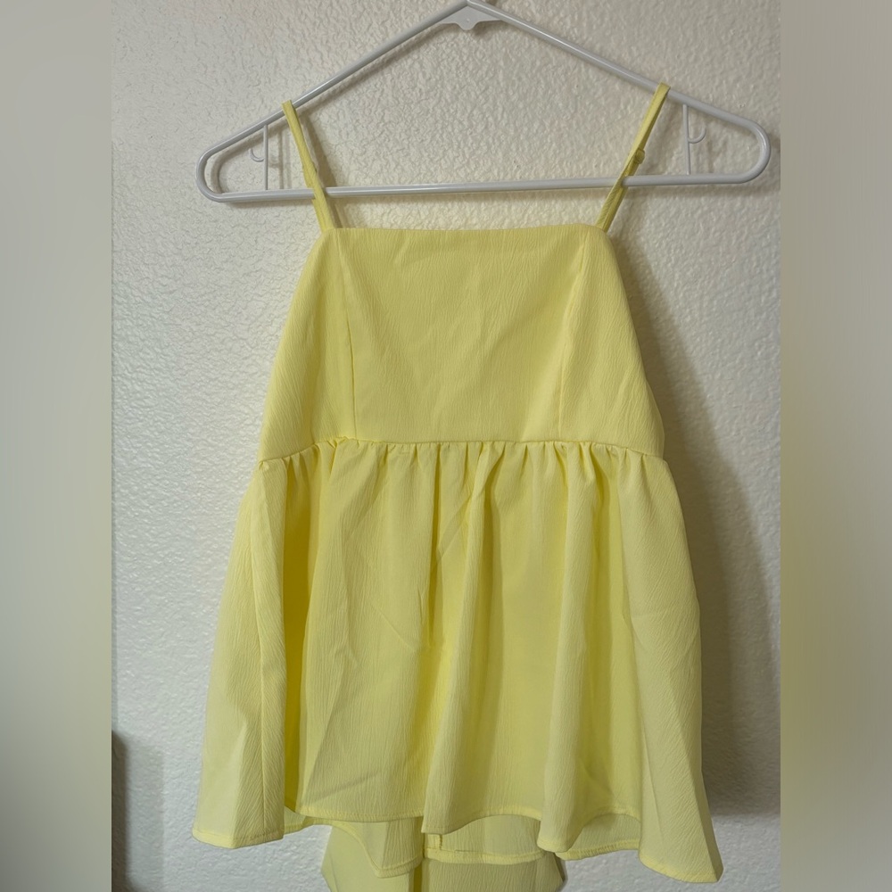 tank top with bow on back, color yellow, size xs, perfect condition never worn